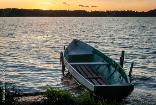 Lonely boat on the river-sunset sun-calm and appeasement.