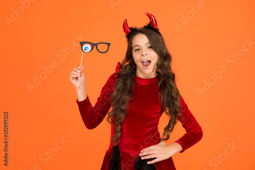 kid with party accessory. child celebrate autumn holiday. teenage girl in devil horns celebrate halloween. happy halloween. trick or treat concept. carnival festive costume of witch. Monster of Sale