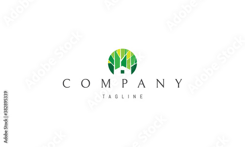 Vector color logo on which an abstract image of the silhouette of a house on a forest background.