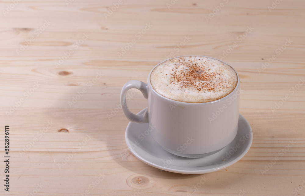 a white ceramic cup of cappucino as a coffee break concept a white ceramic cup of cappucino as a coffee break concept