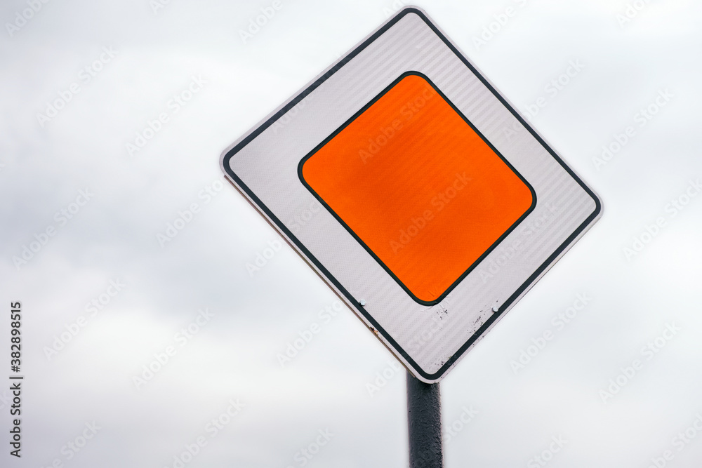 Priority road sign against cloudy sky Priority road sign against cloudy sky