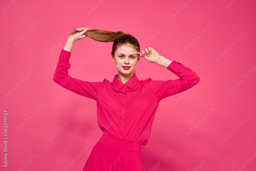 Portrait of a red-haired woman in bright clothes on a pink background cropped view of gesturing with her hands Portrait of a red-haired woman in bright clothes on a pink background cropped view of gesturing with her hands