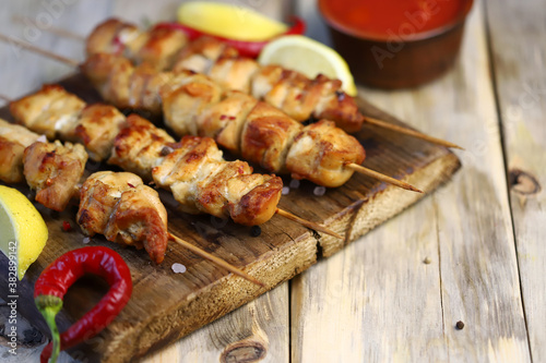 Chicken skewers on wooden sticks. Appetizing homemade mini barbecue. Selective focus. Macro.