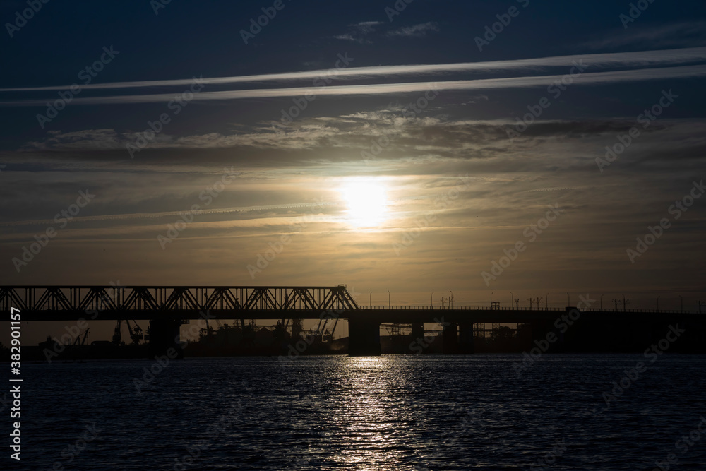 Fototapeta premium Bridge over the river at sunrise. Morning landscape.