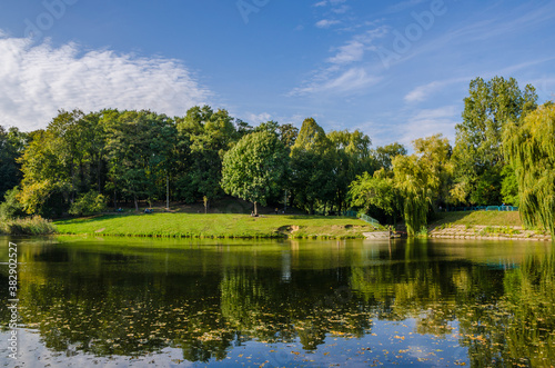 City park in the warm and sunny day during the autumn season. Landscape fulfilled of sunlight