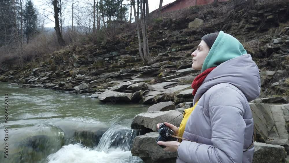 Female traveler enjoying beautiful view of mountain river stream.
Woman tourist taking photos of beautiful mountain river stream on old film camera. Female traveler enjoying beautiful view of mountain river stream.
Woman tourist taking photos of beautiful mountain river stream on old film camera.