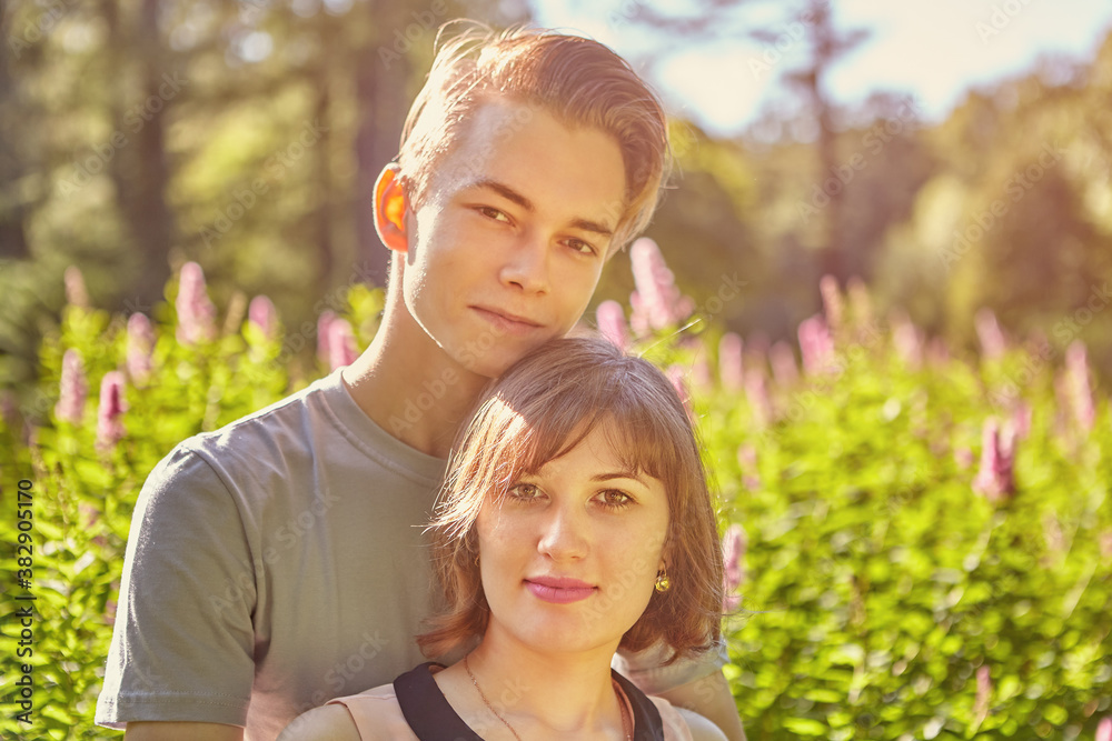 Close up portrait of young Caucasian couple on summer evening garden background. Close up portrait of young Caucasian couple on summer evening garden background.