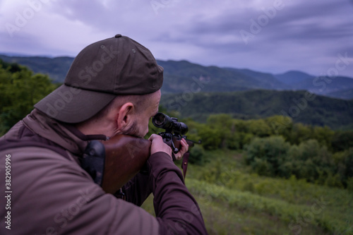 Young man aiming and hunting for wildlife in the nature