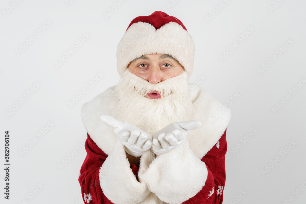 Santa Claus blows off the palm. Isolated background. Santa Claus blows off the palm. Isolated background.