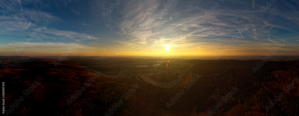 Landscape with the Automotodrom Racing circuit in Brno, Grand Prix of motorbikes and cars in the Czech republic. Panoramic view from the air during sunset
