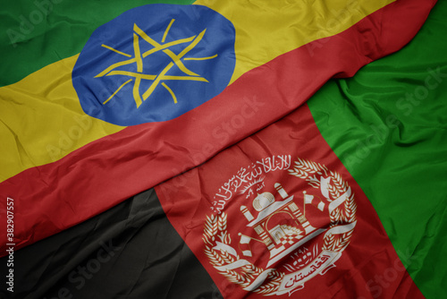 waving colorful flag of afghanistan and national flag of ethiopia . macro