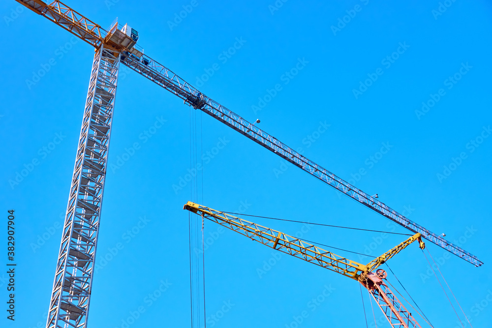 Tower and mobile cranes for lifting loads in the construction of tall buildings. Tower and mobile cranes for lifting loads in the construction of tall buildings.