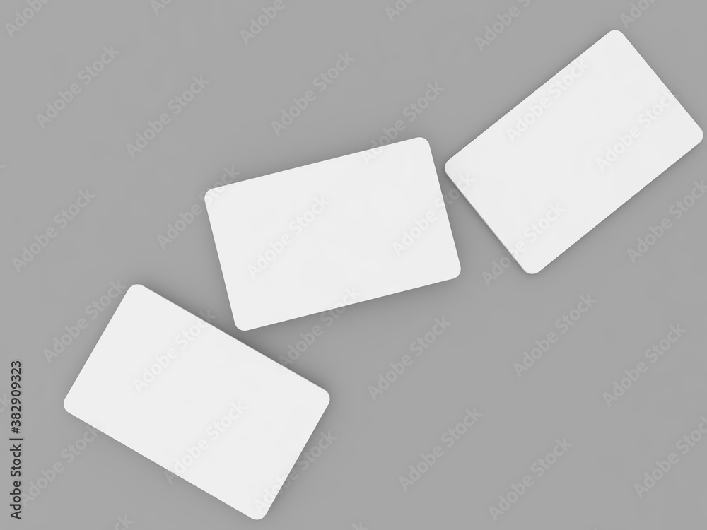 Three white business cards mock up on a gray background. 3d render illustration. Three white business cards mock up on a gray background. 3d render illustration.