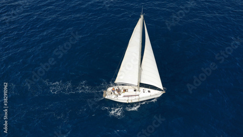 Aerial drone photo of sailboat cruising in Mediterranean deep blue open ocean sea © aerial-drone