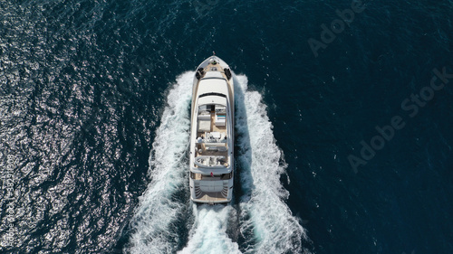 Aerial drone photo of small luxury yacht cruising the Aegean deep blue open ocean sea © aerial-drone