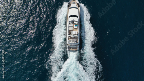Aerial drone photo of small luxury yacht cruising the Aegean deep blue open ocean sea © aerial-drone