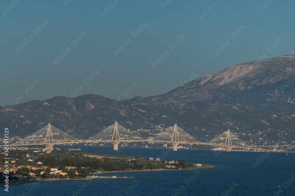 Long suspension bridge over the corinth strait in the gulf of Patras in early evening hours.