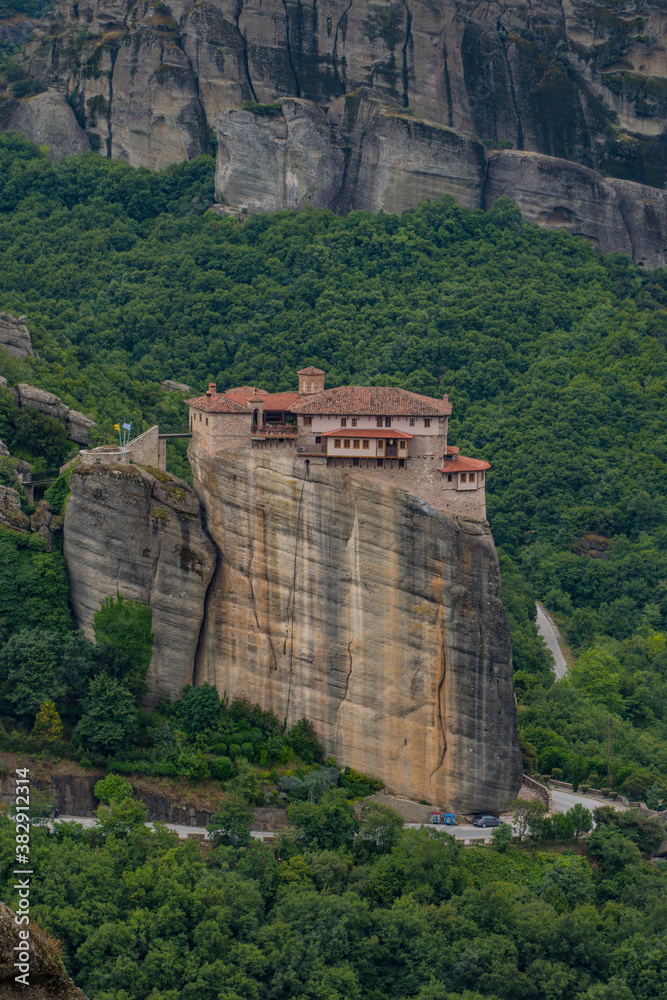 Vertical photo of  Rousanou Monastery. Beautiful scenic panoramic view, ancient traditional greek building on the top of huge stone pillar in Meteora,Thessaly, Greece, Europe on a cloudy day.