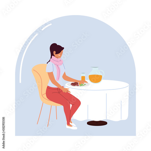 young woman sitting in a restaurant dining alone