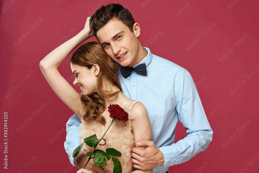 Lovers people with rose in hands on pink isolated background hug emotions happiness romance feelings Lovers people with rose in hands on pink isolated background hug emotions happiness romance feelings
