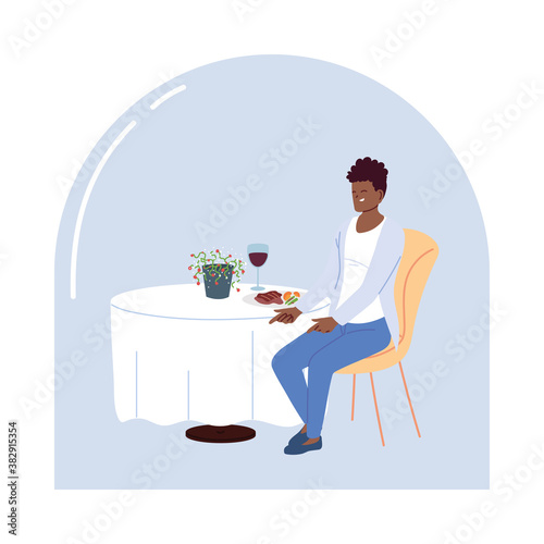 young man sitting in a restaurant having dinner with a glass of wine