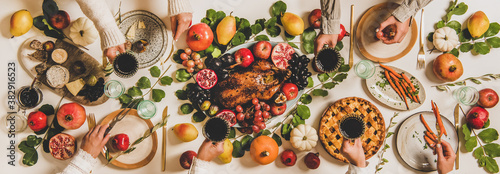 Autumn Thanksgiving, Friendsgiving, family party dinner. Flat-lay of peoples hands with wineglasses celebrating over table with roasted duck, vegetables, cheese board and apple pie, top view