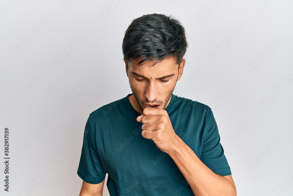 Young handsome man wearing casual clothes feeling unwell and coughing as symptom for cold or bronchitis. health care concept. Young handsome man wearing casual clothes feeling unwell and coughing as symptom for cold or bronchitis. health care concept.