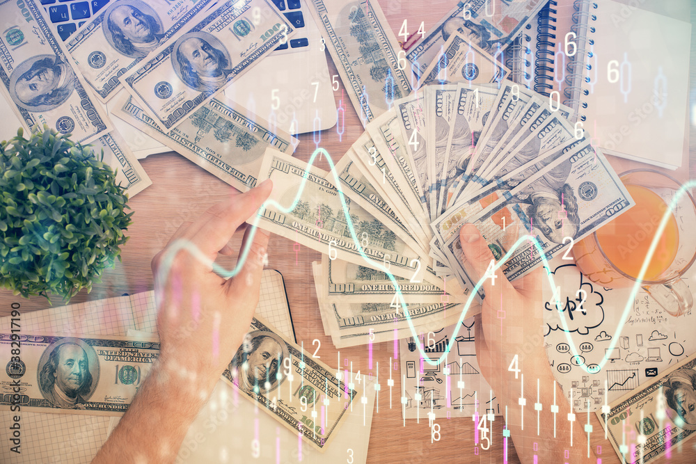 Multi exposure of financial graph drawing hologram and USA dollars bills and man hands. Analysis concept. Multi exposure of financial graph drawing hologram and USA dollars bills and man hands. Analysis concept.