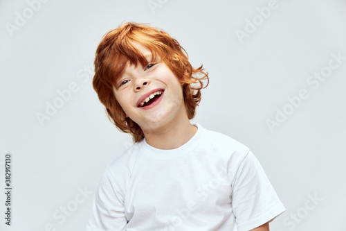cheerful redhead boy wide smile studio lifestyle cropped background 
