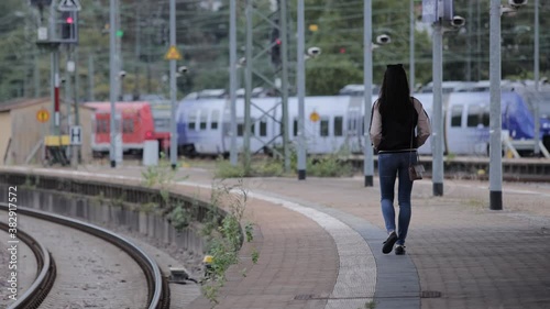 Wallpaper Mural Young Asian woman at a railway station waiting for the train - urban photography Torontodigital.ca