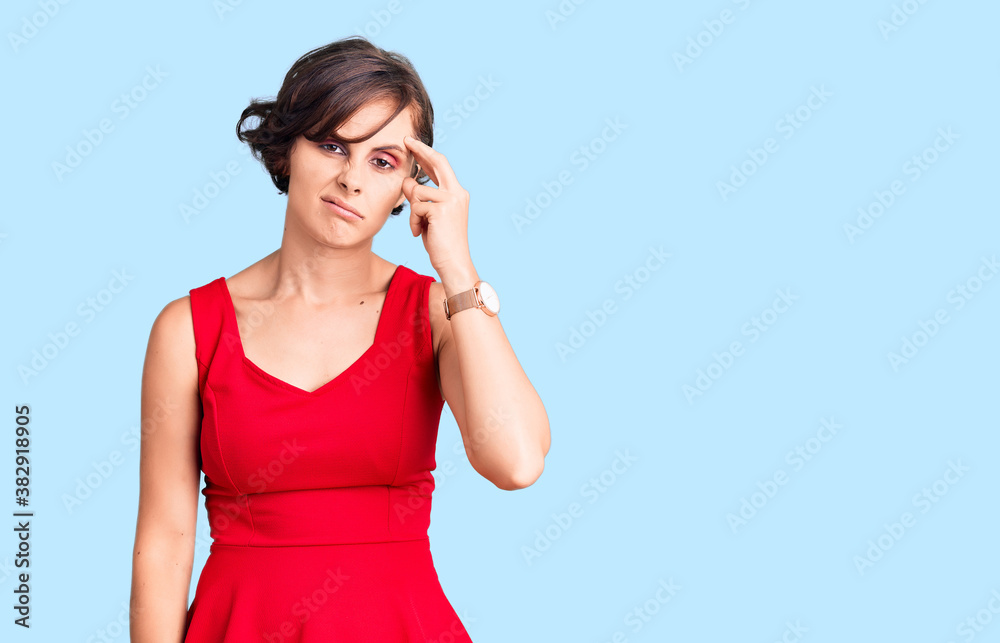 Beautiful young woman with short hair wearing casual style with sleeveless shirt worried and stressed about a problem with hand on forehead, nervous and anxious for crisis