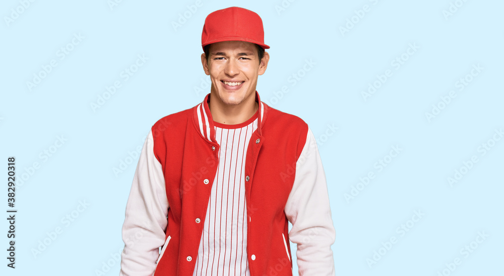 Handsome caucasian man wearing baseball uniform with a happy and cool smile on face. lucky person. Handsome caucasian man wearing baseball uniform with a happy and cool smile on face. lucky person.