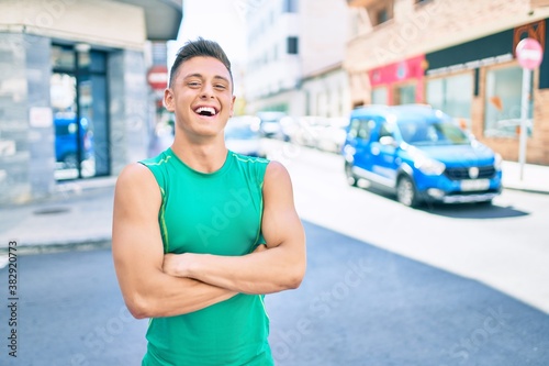 Young hispanic sportsman smiling happy walking at street of city