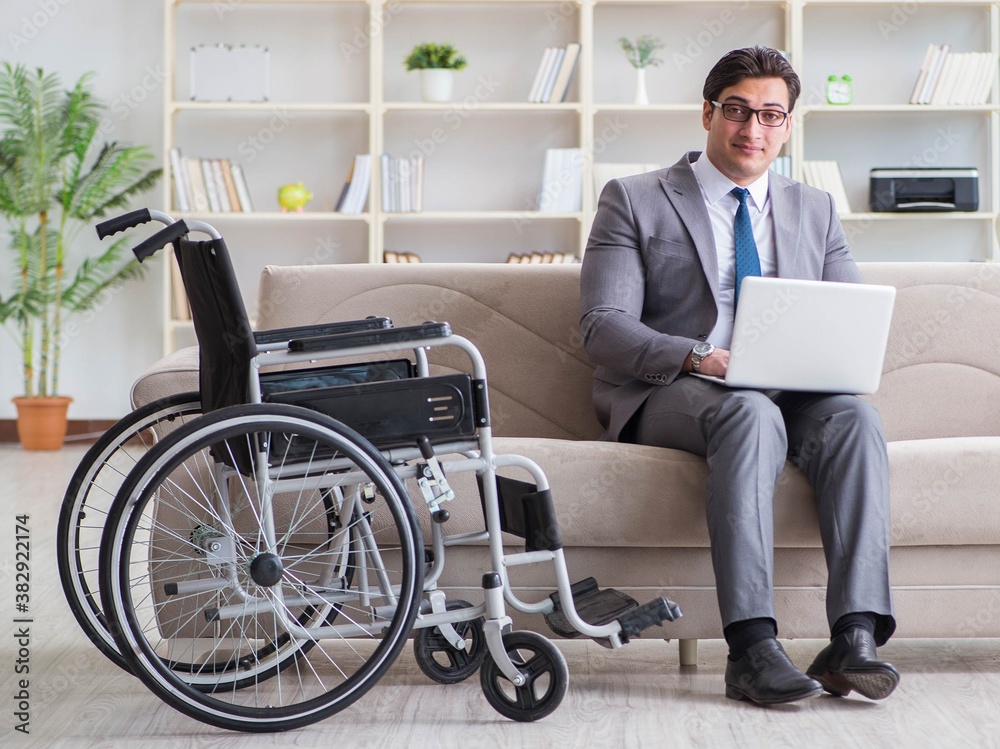 Dsabled businessman on wheelchair working home Dsabled businessman on wheelchair working home