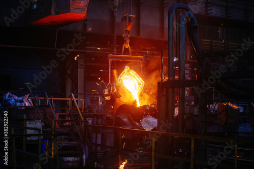 Metal casting process in metallurgical plant. Liquid metal pouring into molds © Mulderphoto