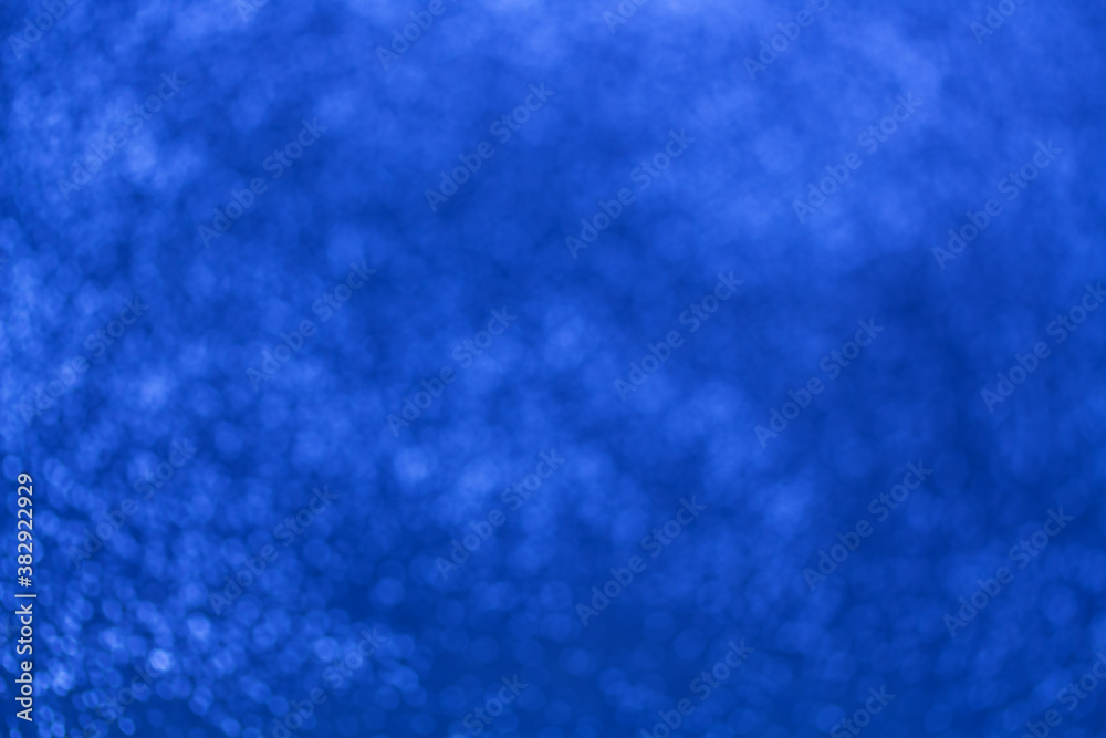 Abstract blurred bokeh bling on bright blue background Abstract blurred bokeh bling on bright blue background