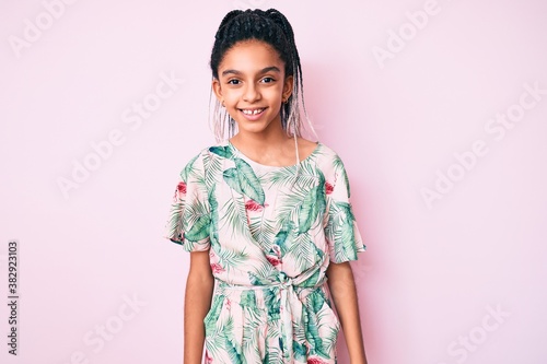 Young african american girl child with braids wearing summer style looking positive and happy standing and smiling with a confident smile showing teeth