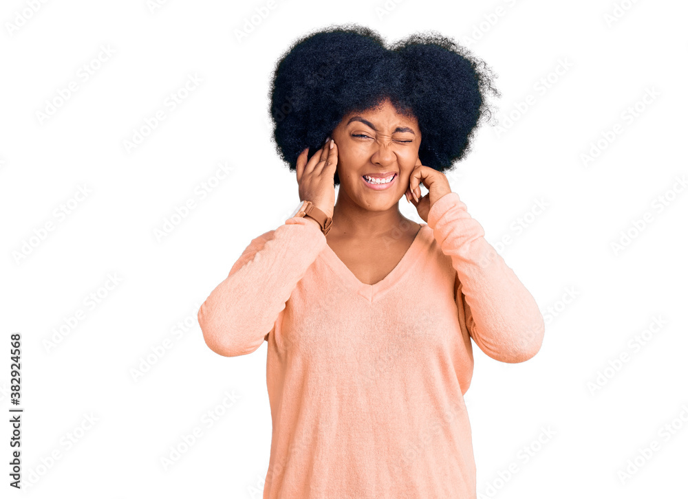 Young african american girl wearing casual clothes covering ears with fingers with annoyed expression for the noise of loud music. deaf concept. Young african american girl wearing casual clothes covering ears with fingers with annoyed expression for the noise of loud music. deaf concept.