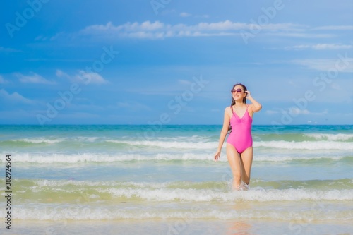 Portrait beautiful young asian woman relax smile around beach sea ocean