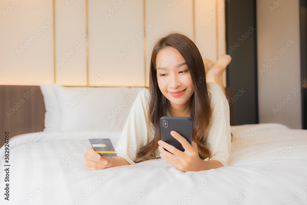 Portrait beautiful young asian woman use smart mobile phone on bed Portrait beautiful young asian woman use smart mobile phone on bed