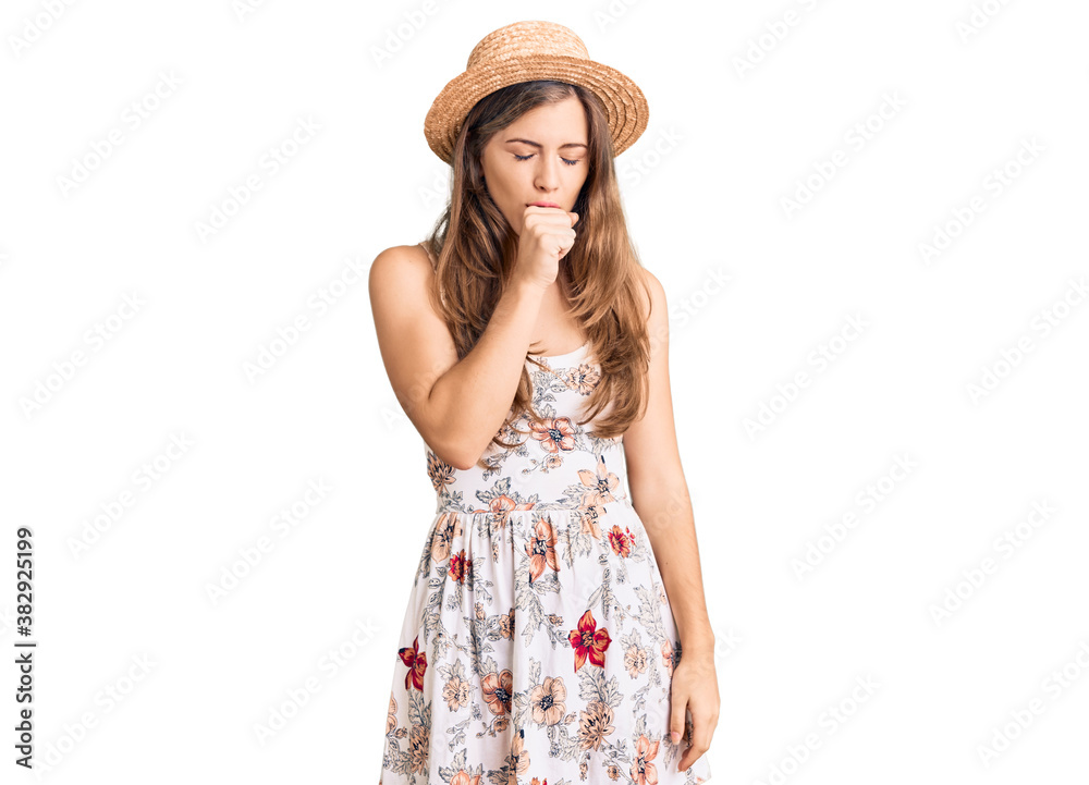 Beautiful caucasian young woman wearing summer hat feeling unwell and coughing as symptom for cold or bronchitis. health care concept. Beautiful caucasian young woman wearing summer hat feeling unwell and coughing as symptom for cold or bronchitis. health care concept.