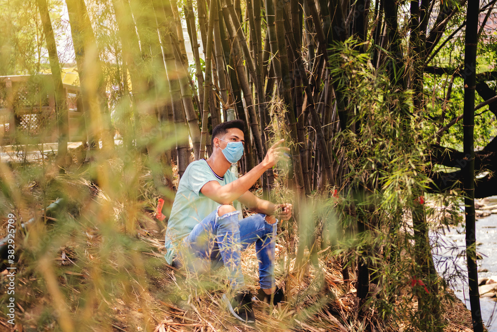 portrait of man sitting with mask in nature portrait of man sitting with mask in nature