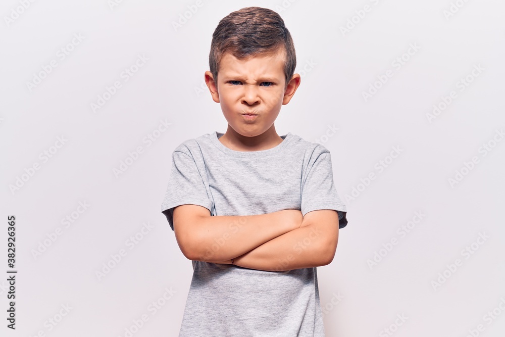 Cute blond kid wearing casual clothes skeptic and nervous, disapproving expression on face with crossed arms. negative person. Cute blond kid wearing casual clothes skeptic and nervous, disapproving expression on face with crossed arms. negative person.