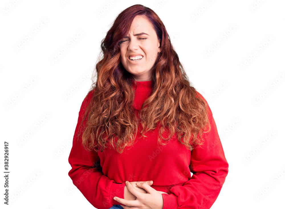 Young beautiful woman wearing casual winter sweater with hand on stomach because nausea, painful disease feeling unwell. ache concept. Young beautiful woman wearing casual winter sweater with hand on stomach because nausea, painful disease feeling unwell. ache concept.