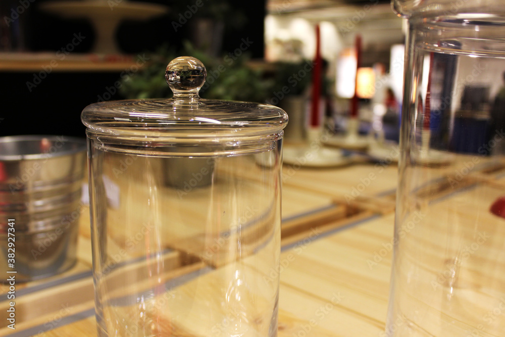 A glass bottle with a lid on the table A glass bottle with a lid on the table