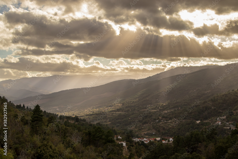 fantastic mountain landscape, with the sun's rays radiating through the cloudy sky, creating a fantastic scenery , Serra da Estrela , Portugal fantastic mountain landscape, with the sun's rays radiating through the cloudy sky, creating a fantastic scenery , Serra da Estrela , Portugal