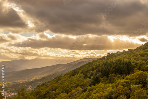 fantastic green mountain landscape  with the sun radiating through the clouds  with its bright rays  natural park of the Serra da Estrela  in Portugal