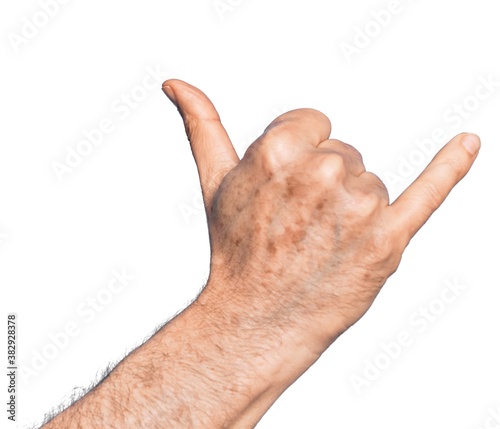 Hand of caucasian middle age man over isolated white background gesturing Hawaiian shaka greeting gesture, telephone and communication symbol photo