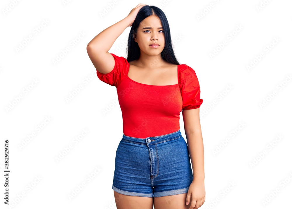 Fototapeta premium Young beautiful asian girl wearing casual clothes confuse and wonder about question. uncertain with doubt, thinking with hand on head. pensive concept.