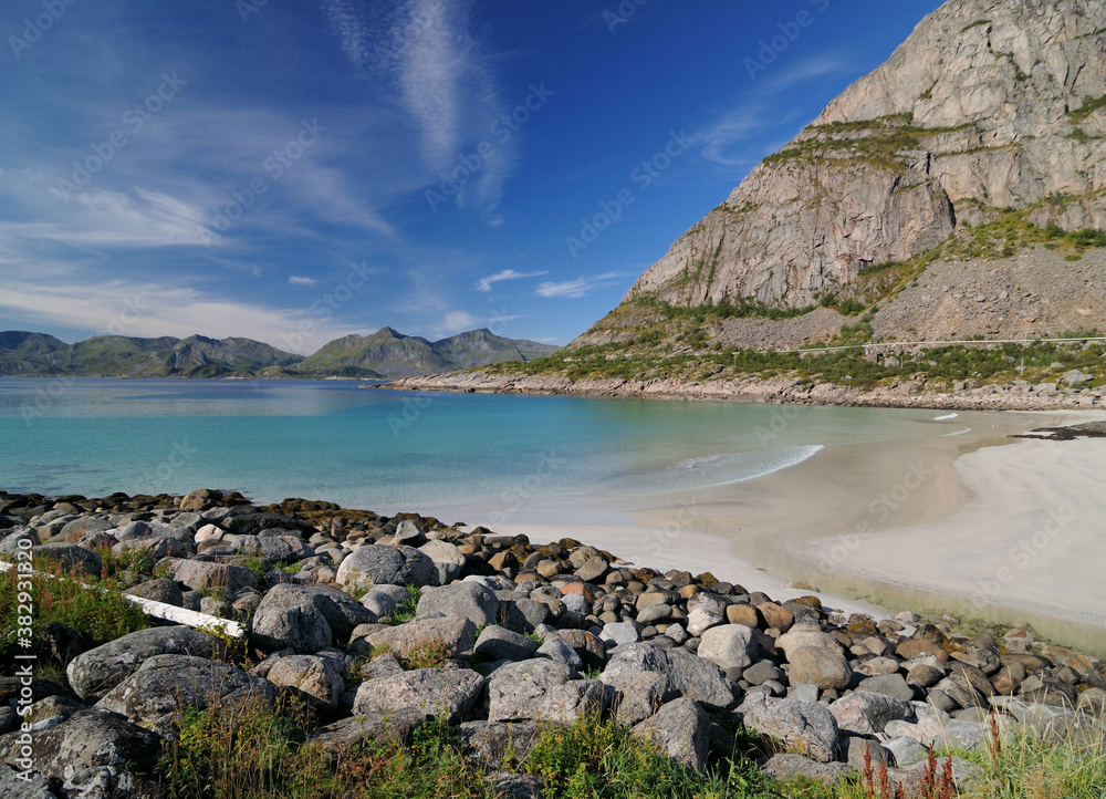 Fototapeta premium Wild Rorvik Beach With Turquoise Water On Lofoten Island Austvagoy On A Sunny Summer Day With A Clear Blue Sky And A Few Clouds